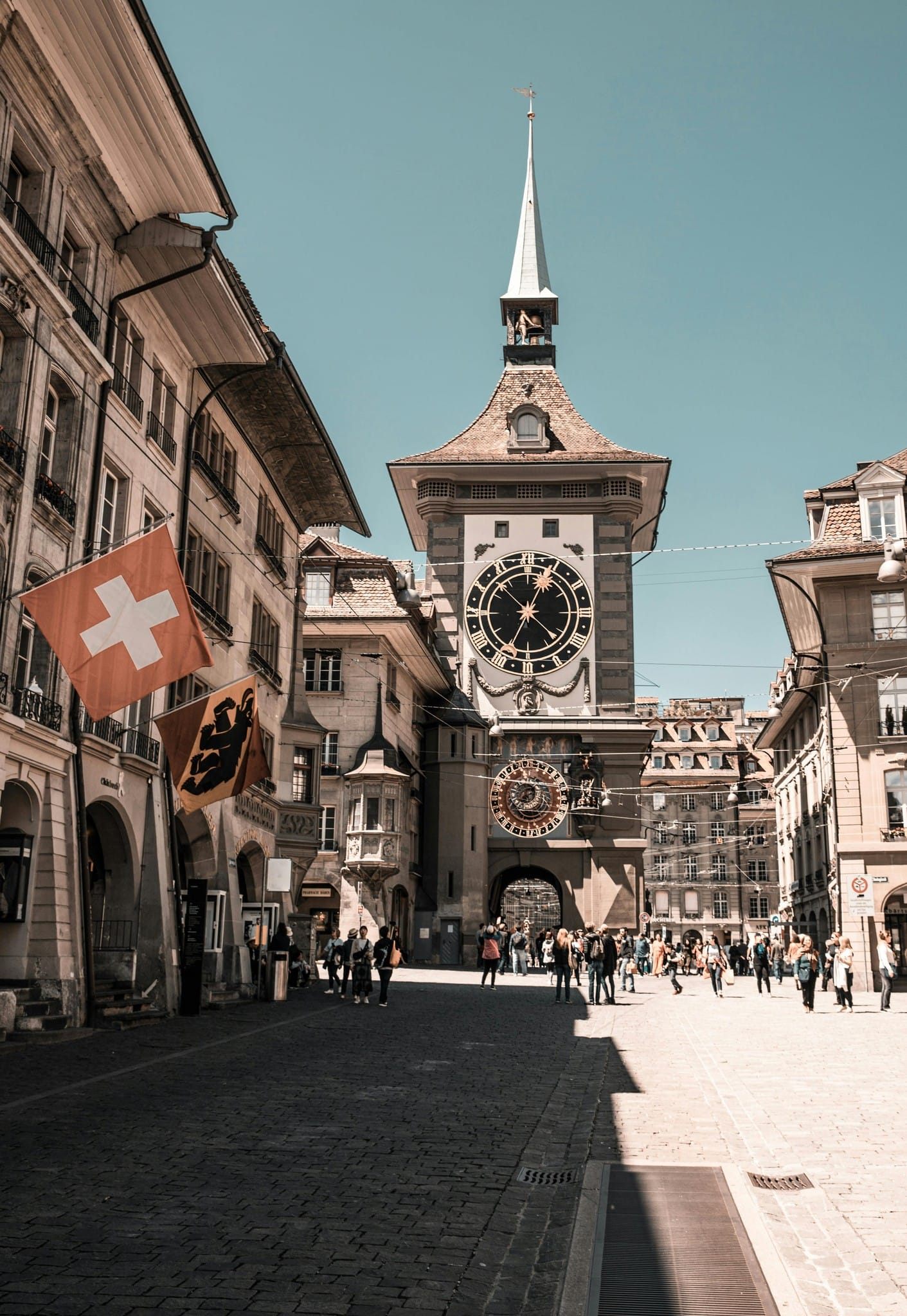 Historic Bern clocktower and Swiss flag